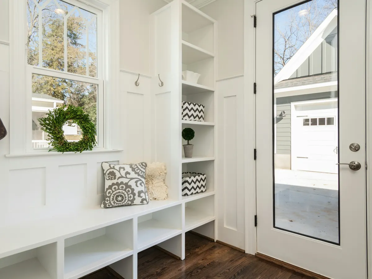 Well lit entry with natural light and custom shelving.